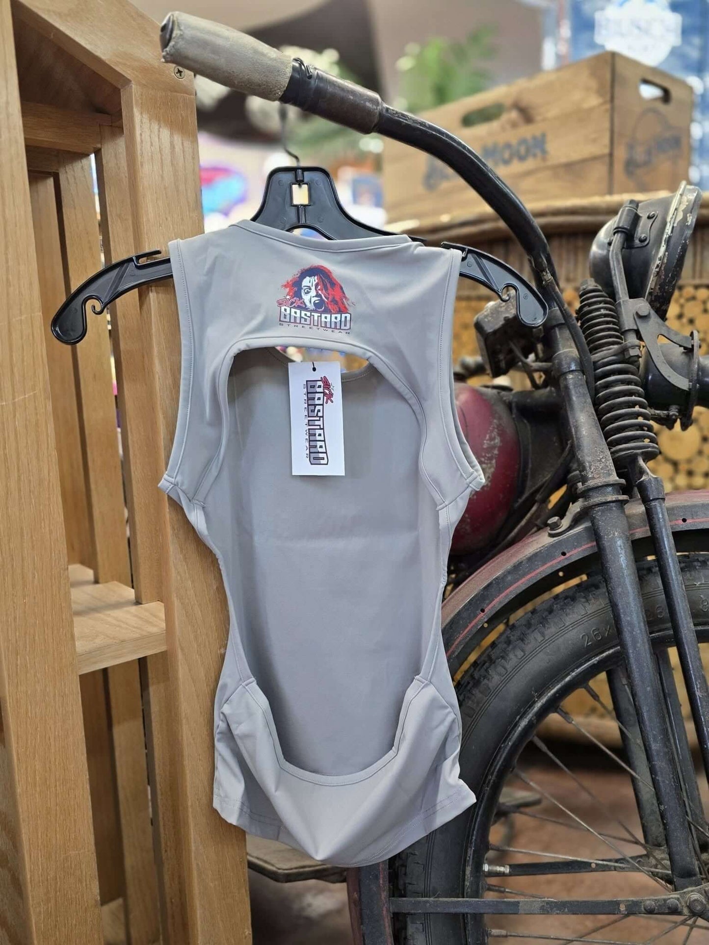 Backless tank top displayed on a hanger, highlighting its unique backless design from Sick Bastard Streetwear.