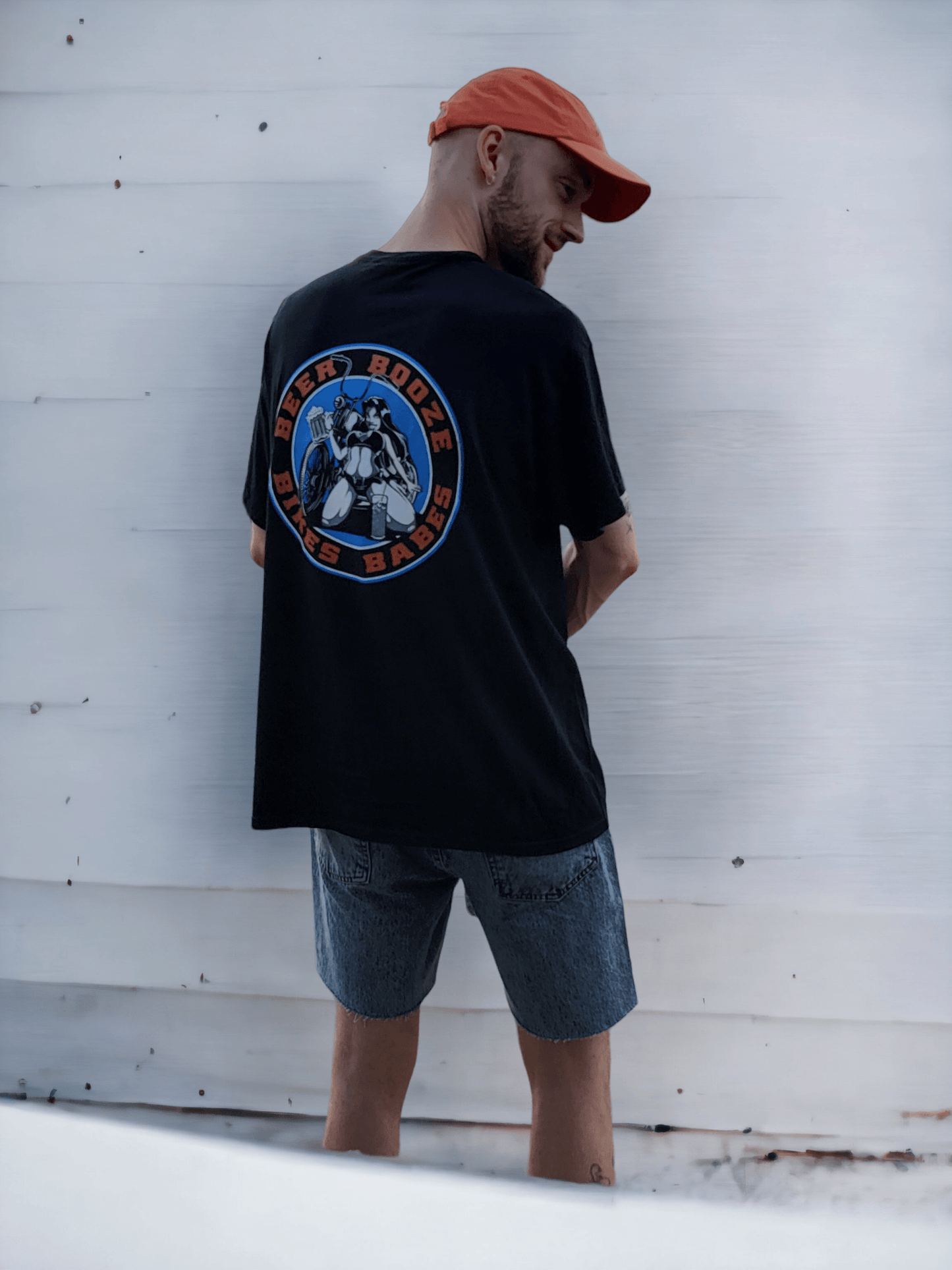 Man wearing a Beer Booze Bikes Babes Short Sleeve T-shirt, showcasing its unique back design.