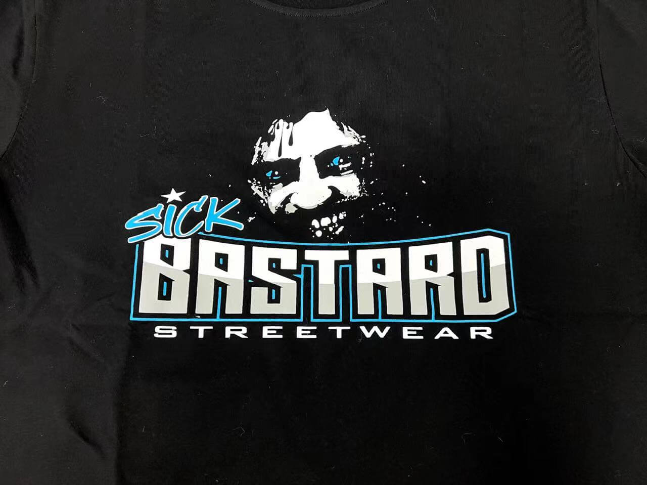 Funny graphic tank top featuring a bold design of Sick Bastard Streetwear with a distressed face graphic.