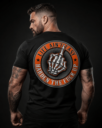 Model wearing black tee with 'Life Ain't Easy, Harden the Fuck Up' design, representing motivational quotes for tough times.