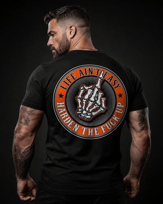 Model wearing black tee with 'Life Ain't Easy, Harden the Fuck Up' design, representing motivational quotes for tough times.