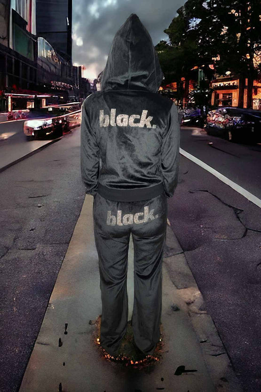 Black velour track pants with rhinestone logo on seat, plush and stylish streetwear