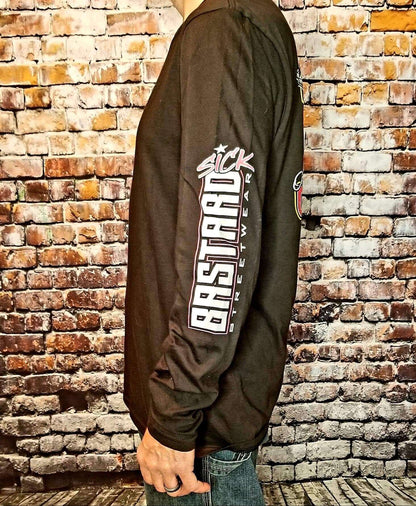 Freedom long sleeve shirt displayed on a model against a brick background, featuring bold graphics and a relaxed fit.