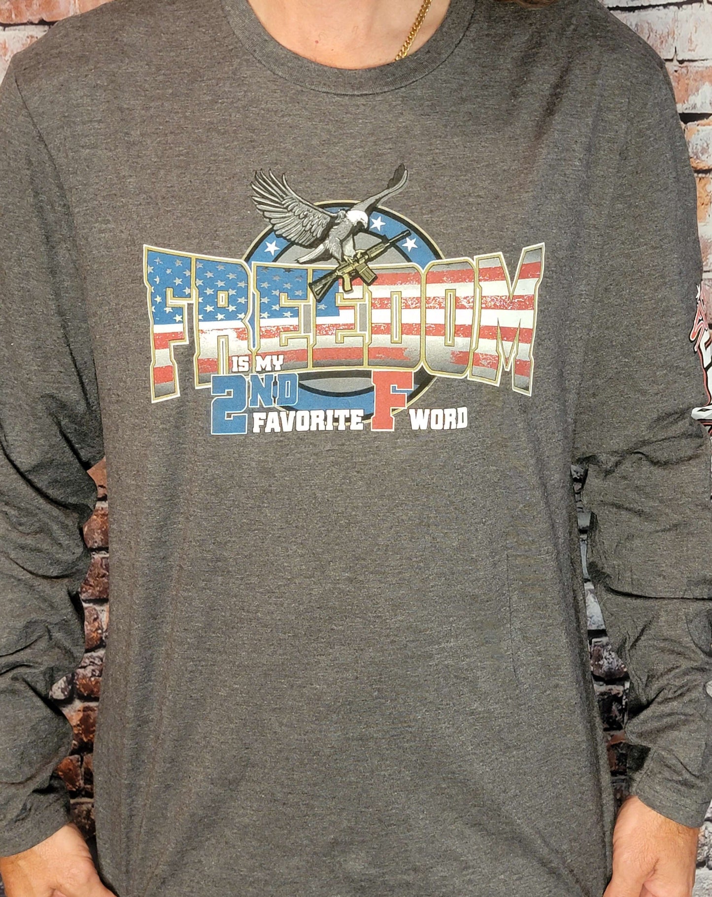 Freedom Long Sleeve Shirt featuring graphic design with the text "Freedom is my 2nd Favorite F Word" on gray fabric.
