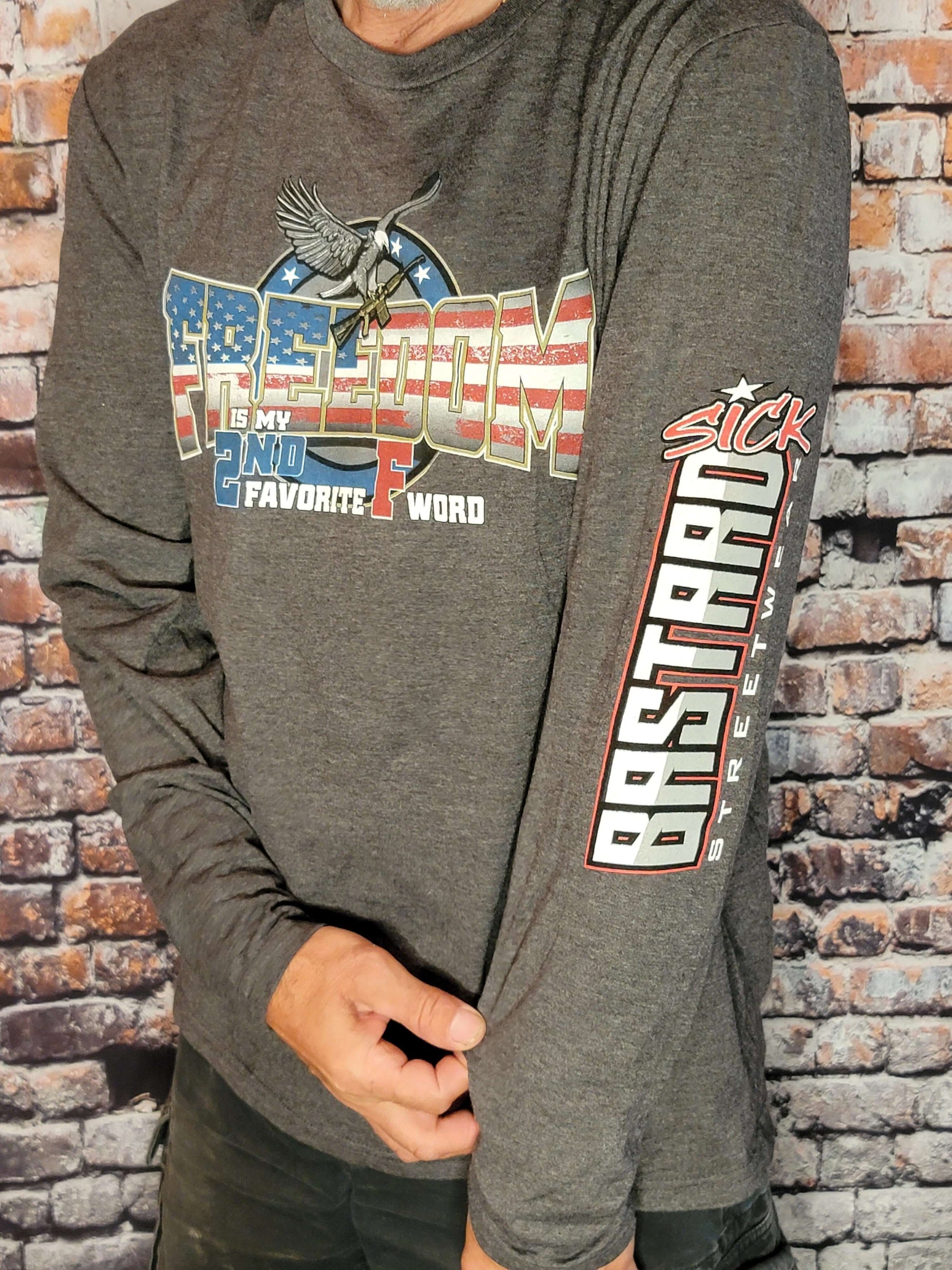 Freedom Long Sleeve Shirt featuring a bold graphic design and statement 'Freedom is my 2nd Favorite F Word' on a grey background.