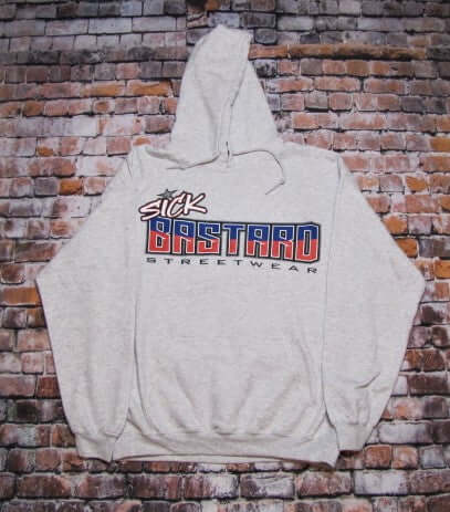 Sick American Bastard Hoodie Pullover in gray featuring bold logo on a brick background.