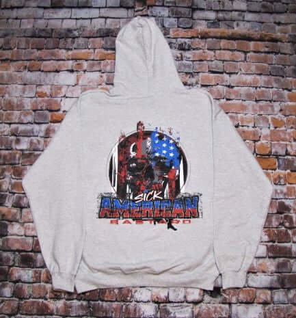 Sick American Bastard Hoodie Pullover with bold graphics on the front and back, displayed against a brick background.