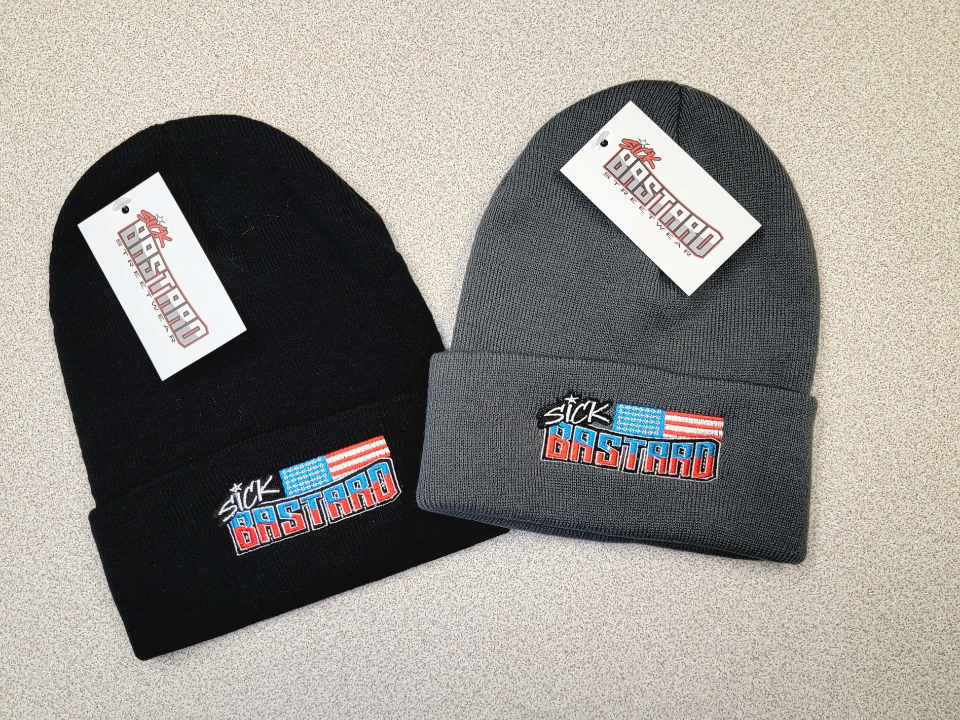 Sick Bastard Flag Beanie collection in black and gray showcasing bold streetwear logo design.