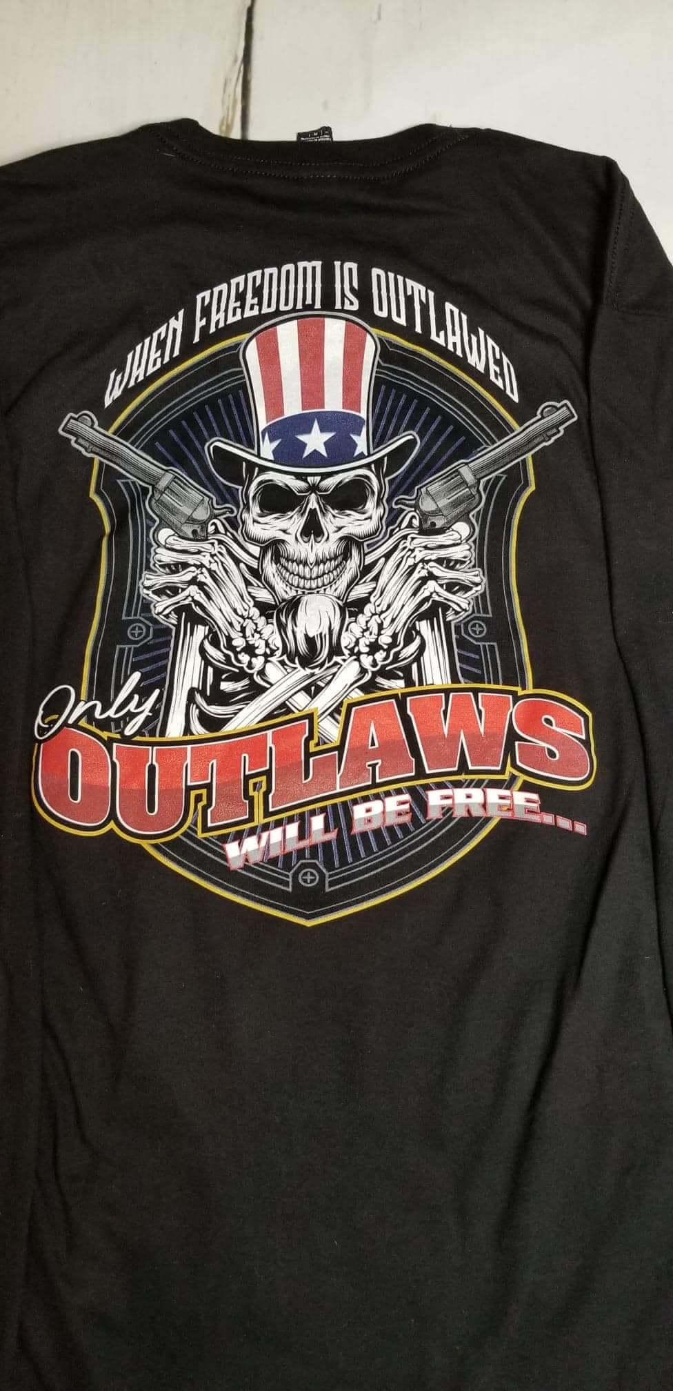 Freedom long sleeve shirt featuring a skull and patriotic design with the phrase 'When Freedom is Outlawed Only Outlaws Will Be Free.'